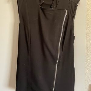 Black sleeveless jacket like top.